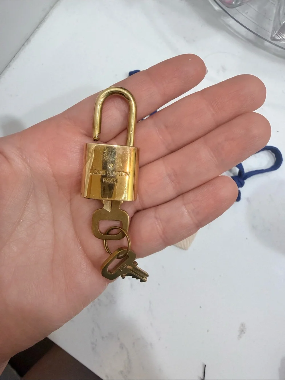 Louis Vuitton Gold Padlock Key Charm with Cream Pouch and Blue Drawstrings